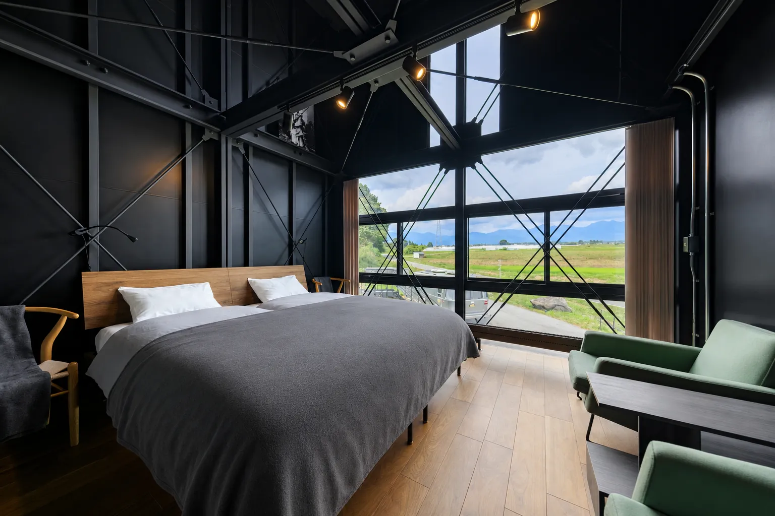 Second-floor bedroom with big windows facing farmland and mountains