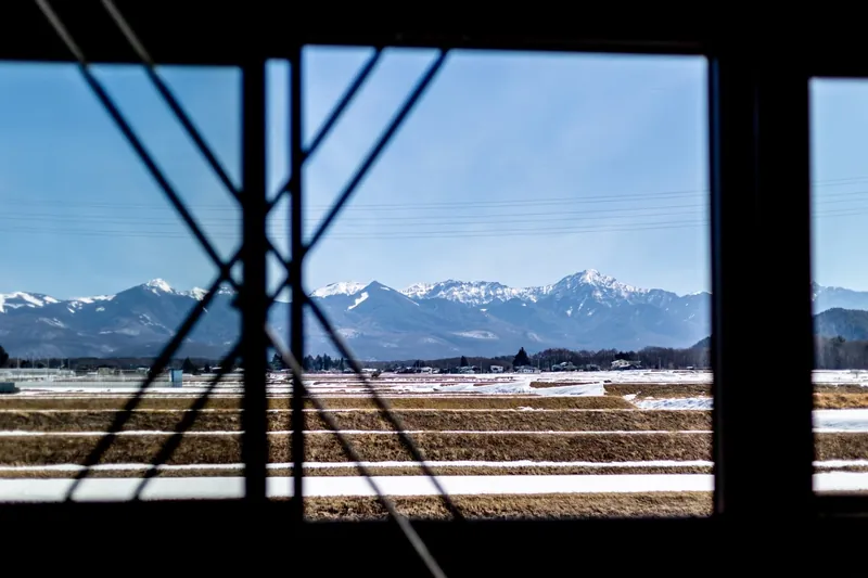 Snowy peaks seen through the cross braces